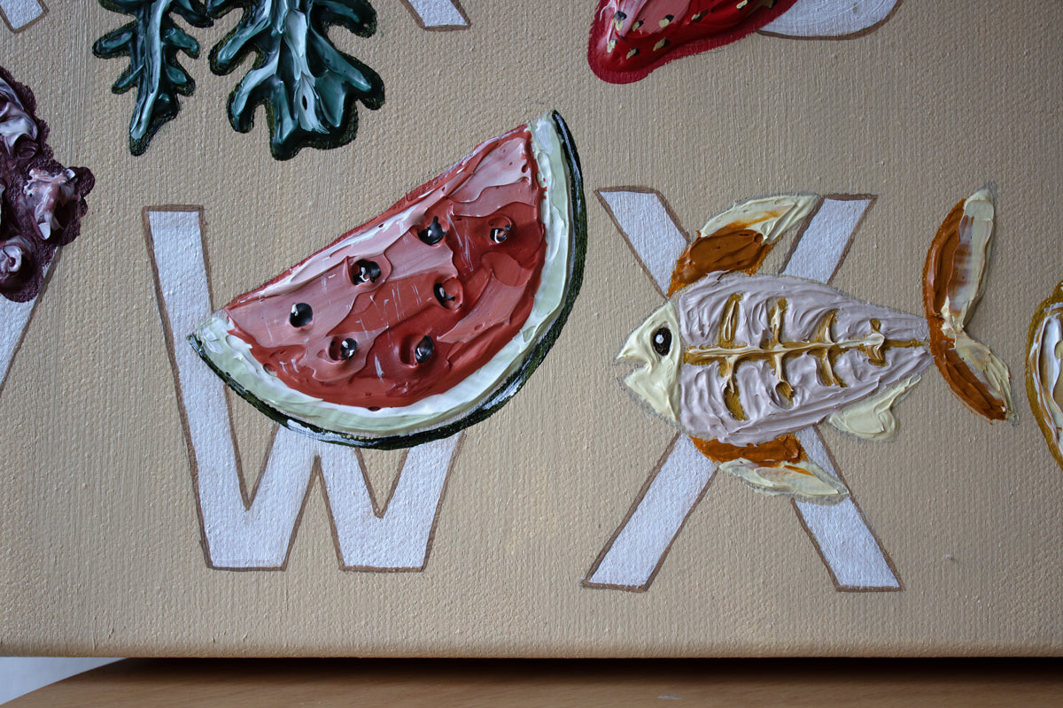 Alfabeto original painting by Marissa Lico. Decorative letters 'W', 'X', and 'Y' with watermelon and fish designs on a beige background.