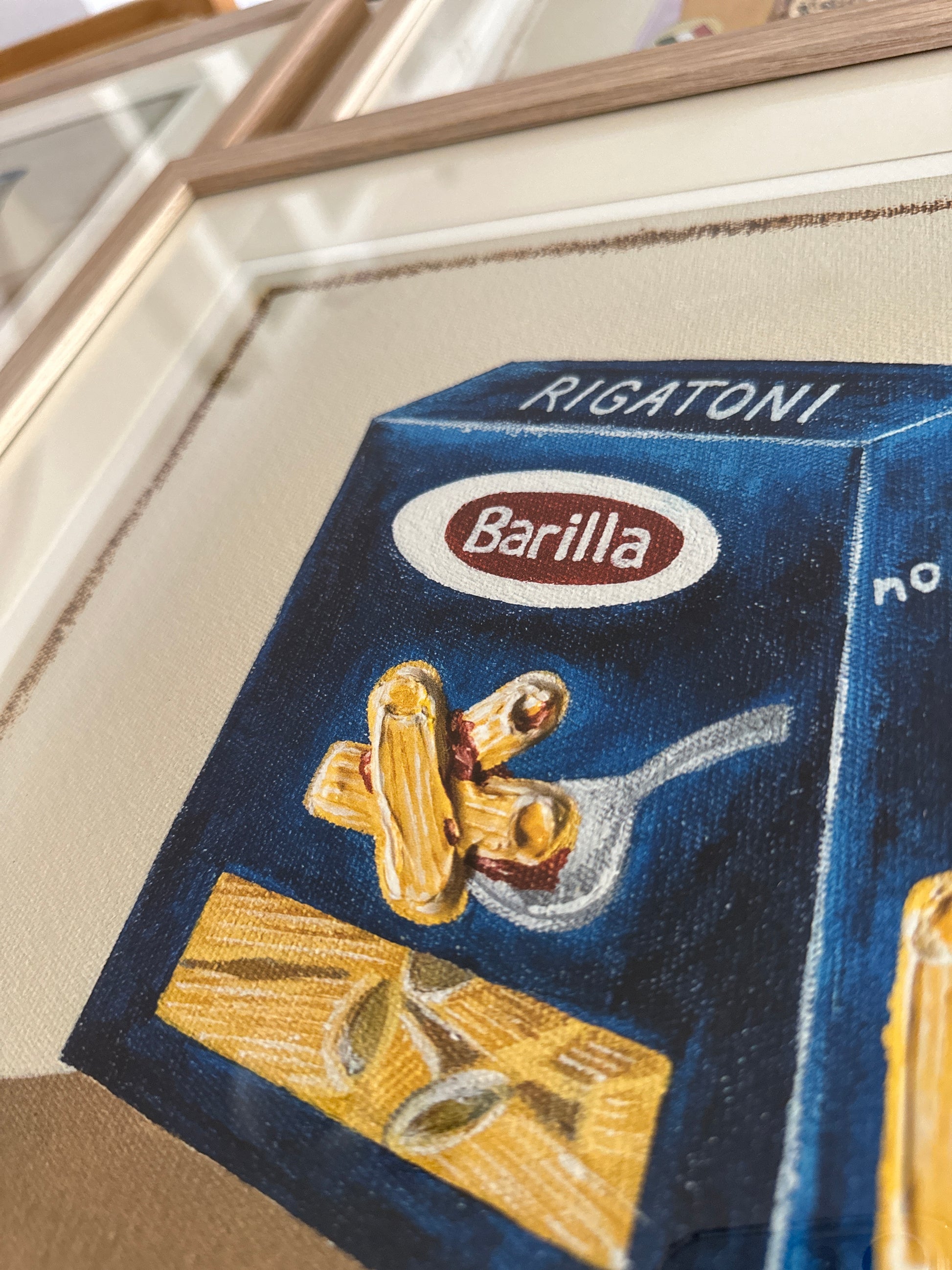 Barilla fine art print by marissa lico. Close-up of a Barilla Rigatoni pasta box painted on a canvas surface.