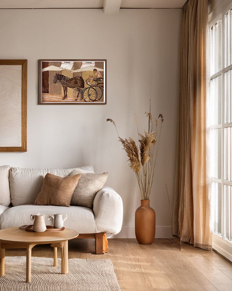 Horse Chanel wall art print by Marissa Lico. Living room with a white sofa, wooden coffee table, and decorative elements including a framed print.