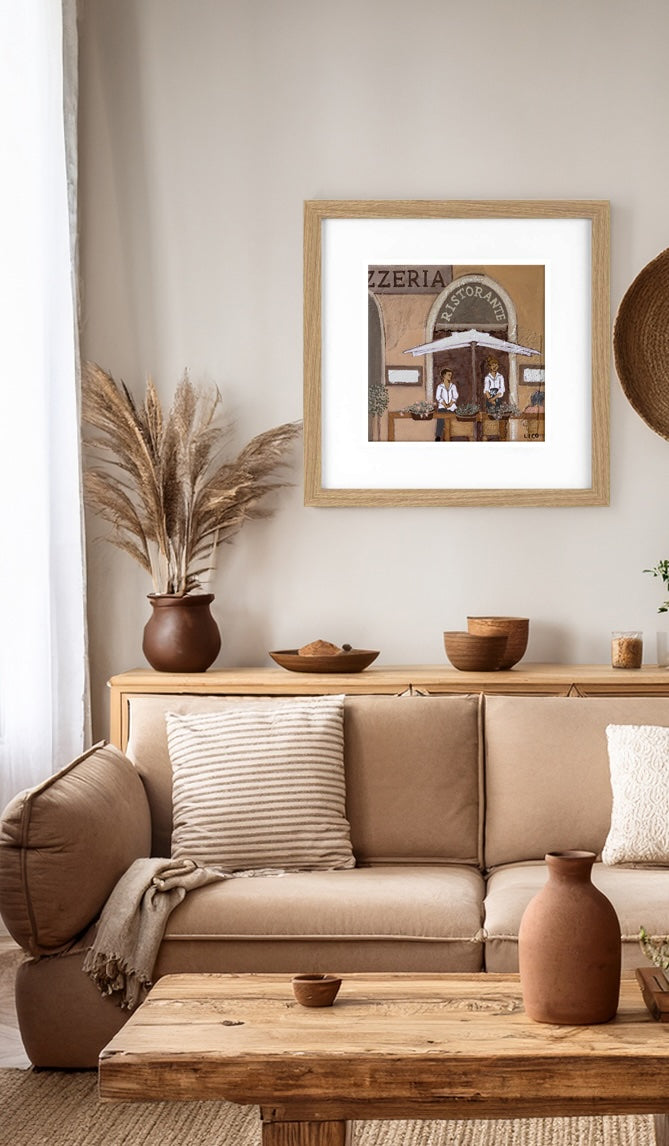 Pizzeria fine art print by marissa lico, Living room with beige sofa, wooden coffee table, and framed print on wall.