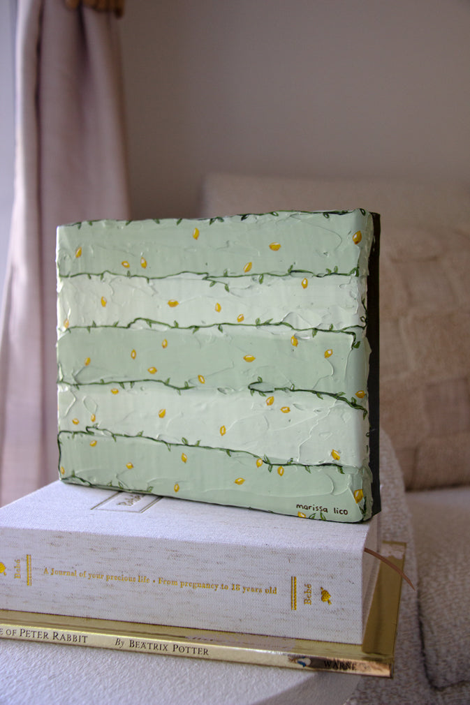Tanto Limone original painting by Marissa Lico. Green textured painting with lemons on a stack of books in baby's nursery.