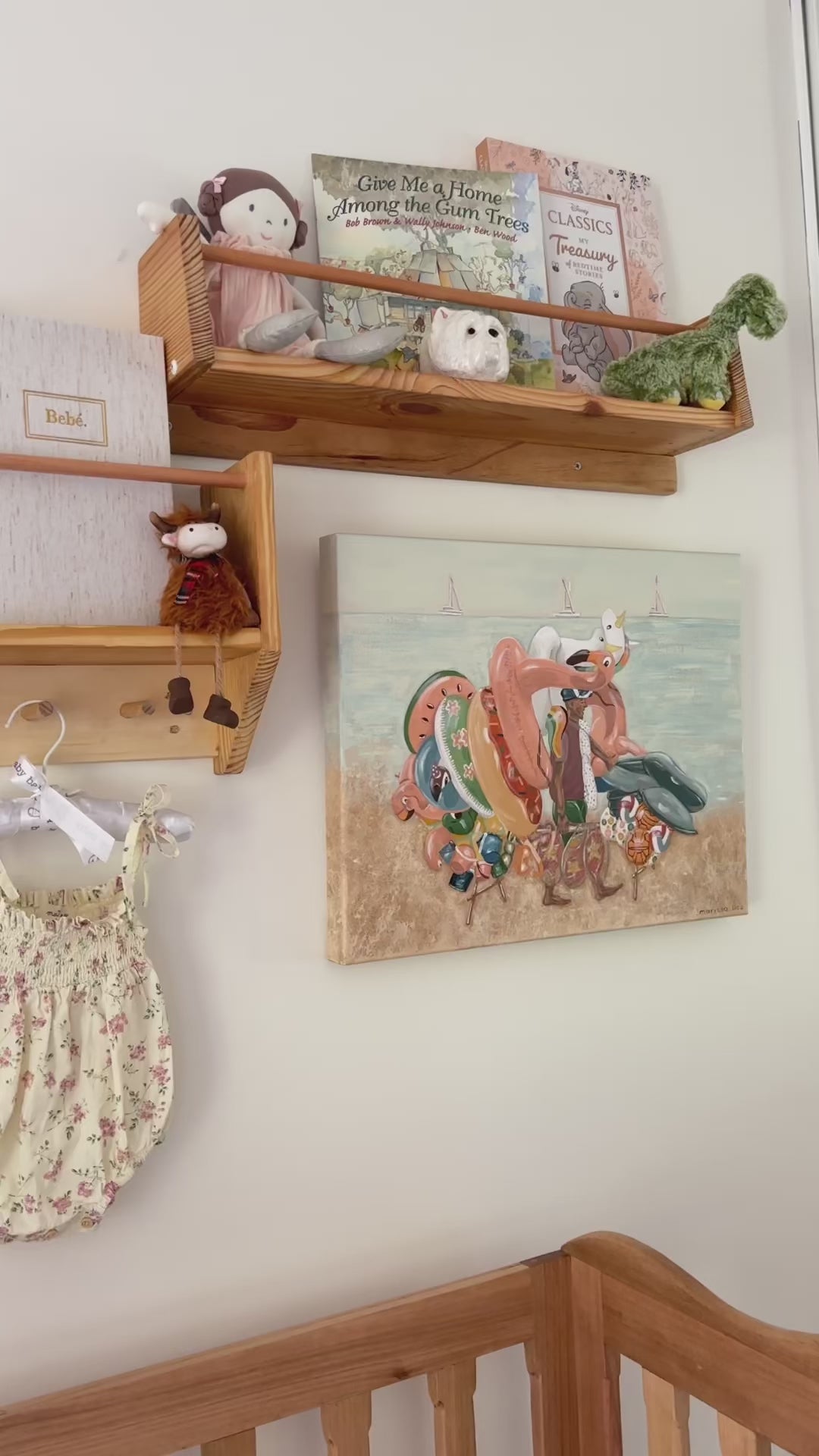 Beach Games original painting by Marissa Lico, displayed in a baby's nursery among books and toys.